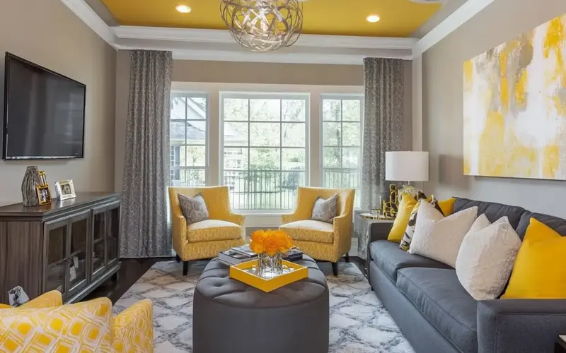 Yellow and Grey Living Room Decor Ideas for a Cozy Space: The interplay of colors in interior design profoundly impacts a space's ambiance. When we combine yellow and grey in a living room setting, we blend sunshine with serenity. Yellow, often associated with happiness and optimism, injects warmth and energy, while grey brings a sense of calm and sophistication. This color scheme's versatility allows it to seamlessly integrate into various design styles, from the sleek lines of modern minimalism to the rich textures of traditional decor.